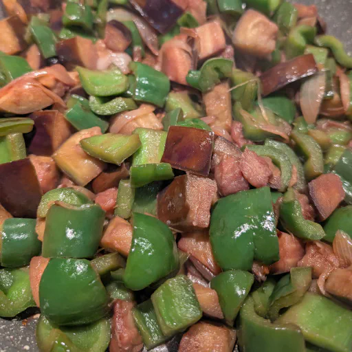 Red wine being added to deglaze the vegetables in the pan